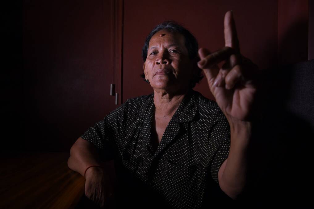 Bou Sokhom holds up a clean finger to indicate she will be boycotting Cambodia's general election. Photo: Kate Geraghty