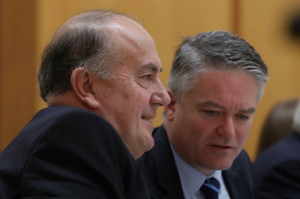 Treasury head John Fraser with Finance Minister Mathias Cormann during estimates hearings. An excellent rationale for the levy is to fund the implied guarantee that the governments gives to the big banks, yet Fraser says that's not the tax's purpose. Photo: Andrew Meares