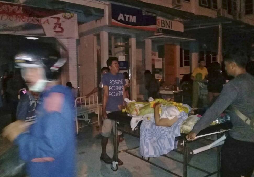 A patient is evacuated from a hospital after the earthquake hit Poso on the island of Sulawesi on Friday. Photo: AP
