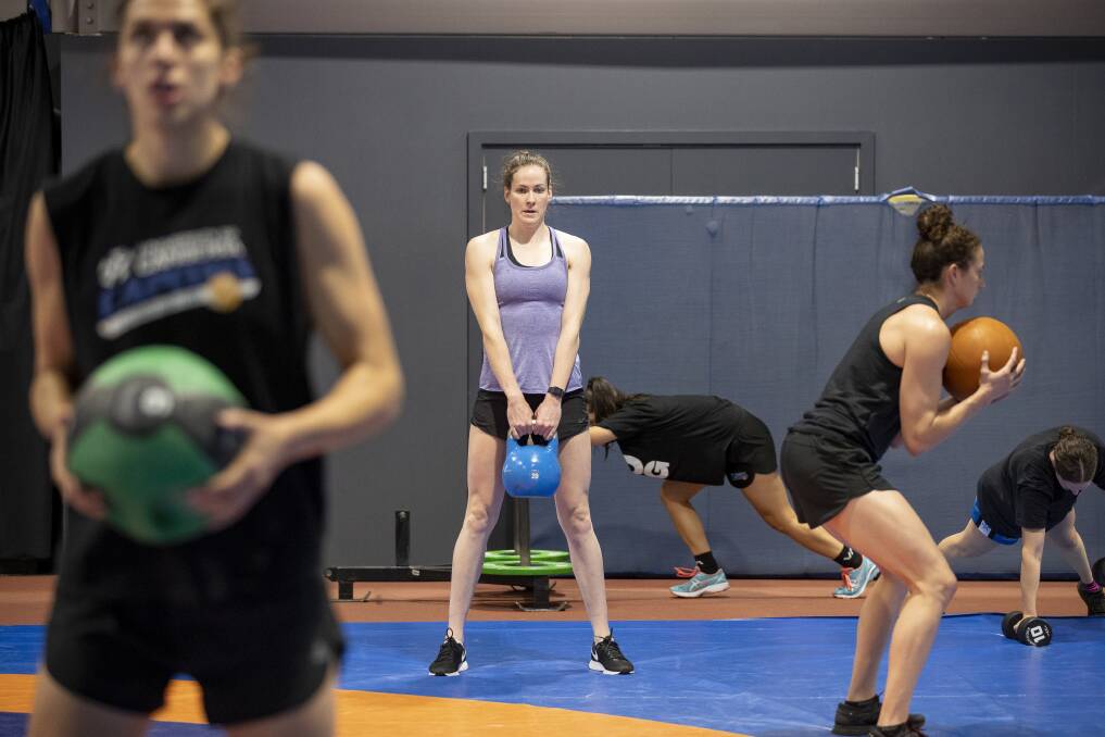 Eyes on the prize: The Canberra Capitals' Marianna Tolo, Keely Froling, Abby Cubillo, Kelsey Griffin, and Kelly Wilson hit the AIS gym. Photo: Sitthixay Ditthavong