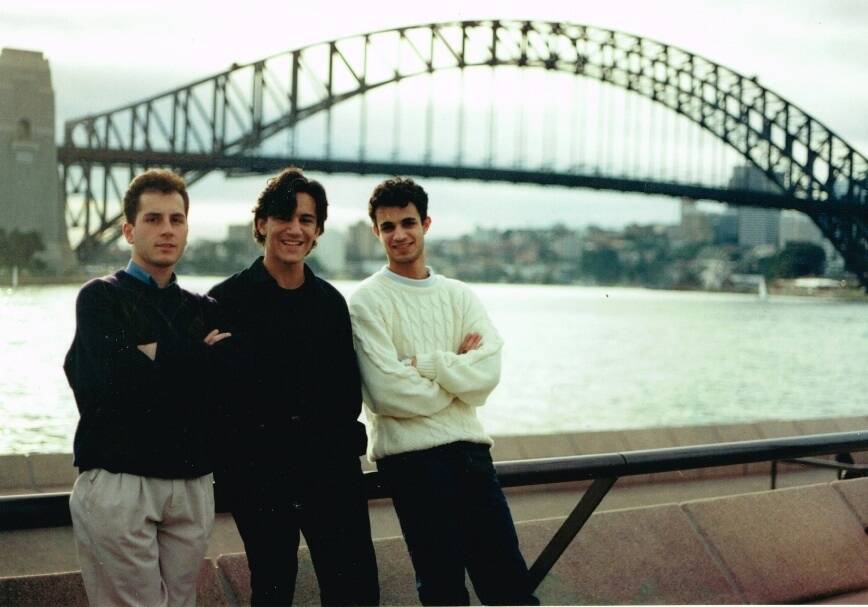 Ross Farhadieh (centre) in 1993 during his medical school days, sporting era-appropriate hair. Photo: Supplied