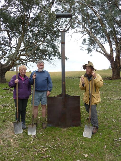 Liz and John Baker and Tim check out the giant-sized shovel sculpture. Photo: Supplied