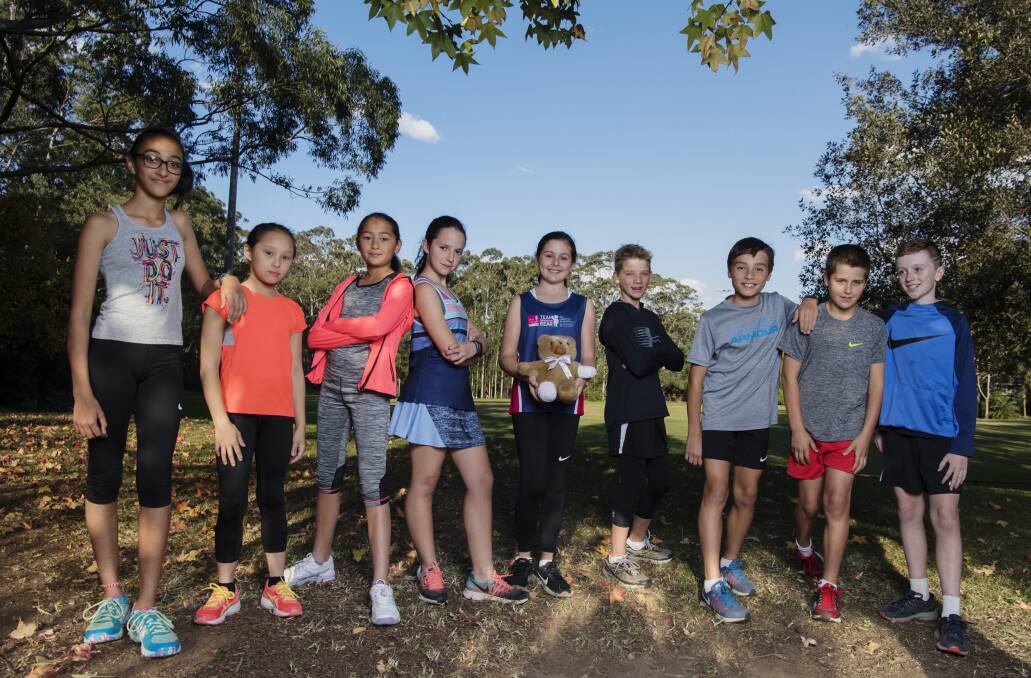 Eden Cowdery (holding a bear) has inspired other students to do the City2Surf including Misha Dhawan, Cassie Tinyow, Sophie Wang, Raquel Quintal,  Ollie Webber, Josh Riddle, Angus Till and Oscar Harvey.  Photo: Louise Kennerley
