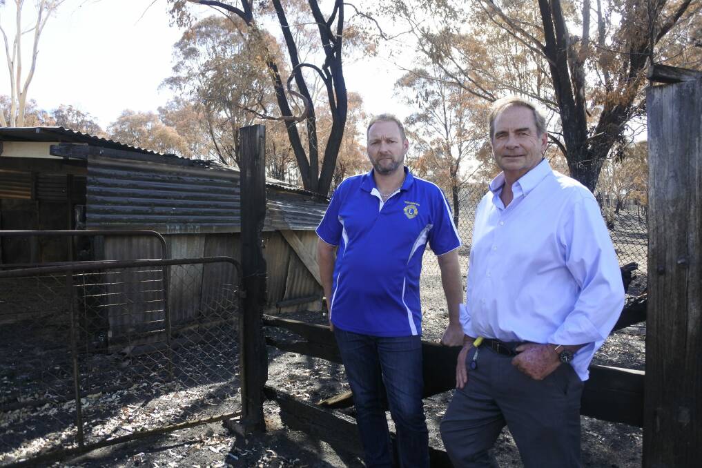 Queanbeyan Lions Club president Jamie Walker (left) has donated $20,000 on behalf of the club to the Queanbeyan-Palerang Regional Council's Carwoola Bushfire Appeal, organised by council administrator Tim Overall (right). Photo: Clare Sibthorpe