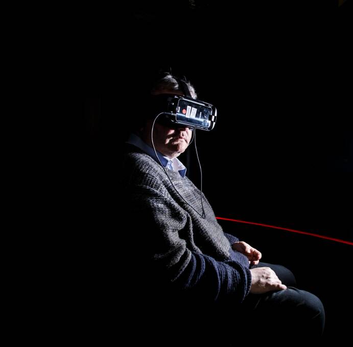 Lynette Wallworth's 'Collisions' virtual reality film blends oral history, film, and sci-fi into a visceral immersive experience. Journalist Ron Cerabona is pictured trying the experience. Photo: Sitthixay Ditthavong