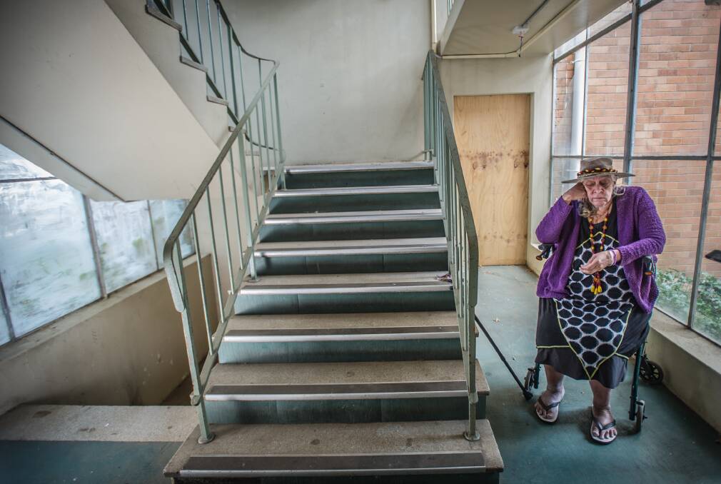Judith Kelly sits outside her flat, inside the public housing block on the corner of Condamine Street and Northbourne Avenue. Photo: Karleen Minney