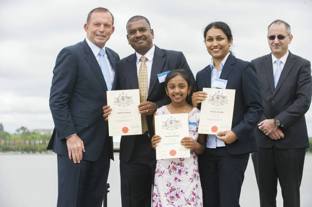 Tony Abbott congratulates the Devaprasanna family - who arrived from India in 2000 - on their Australian citizenship. Photo: Rohan Thomson