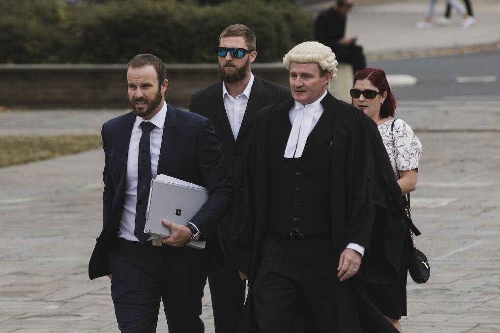 Alister Spong (second from left), joined by his wife, solicitor Jacob Robertson (left) and barrister Steven Whybrow (right)  arrives at the ACT Supreme Court for the trial over his friend's death at Summernats. Photo: Jamila Toderas