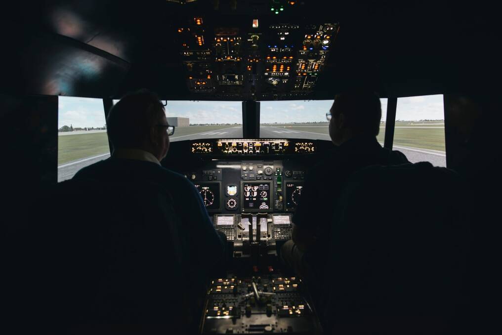 Canberra Times journalist Ron Cerabona flies a plane with pilot Nick Walsh at the Flight Simulator in Fyshwick. Photo: Rohan Thomson