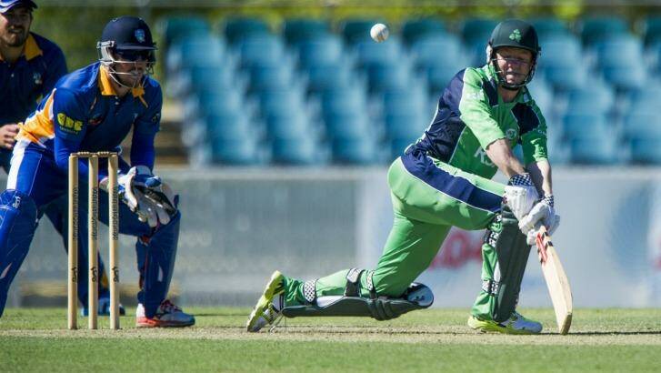Nial O'Brien of Ireland plays a sweep shot against the ACT Comets at Manuka Oval. Photo: Jay Cronan