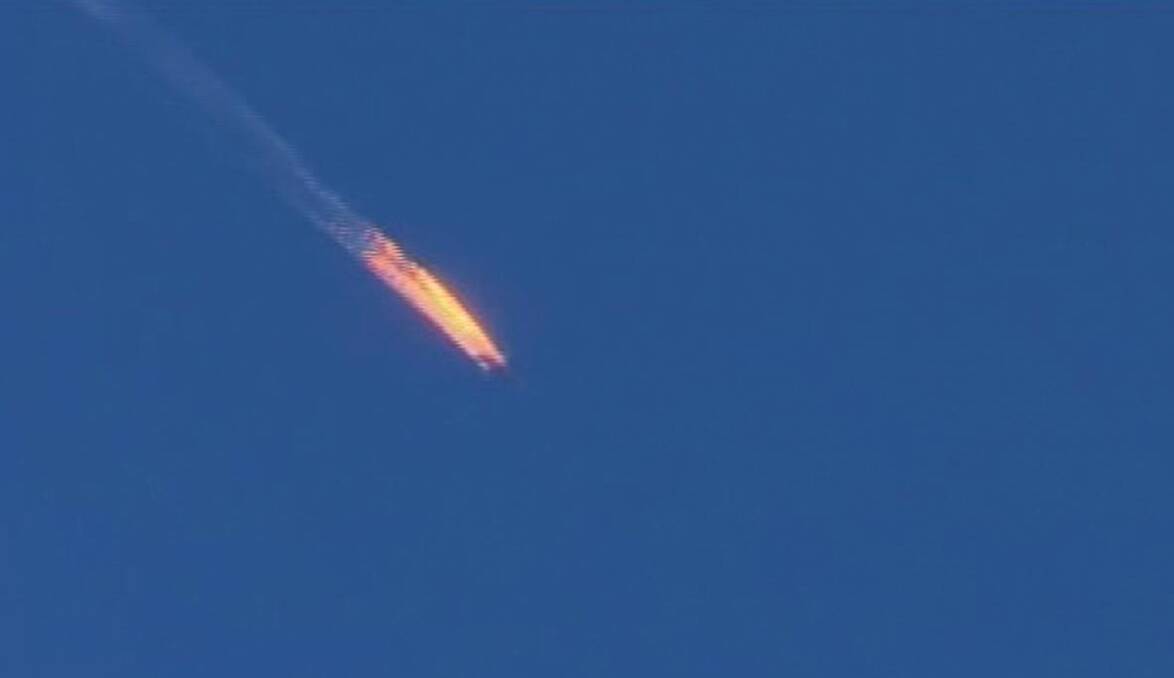 The Russian warplane on fire before crashing. Photo: AP