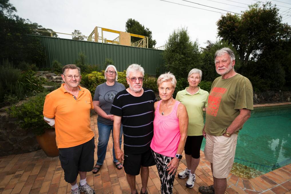 Residents John Hill, Alexandra Geue, Russell Johnson, Joan Johnson, Margaret Cooper and John Cooper are concerned about the construction of a building on a former Mr Fluffy site.  Photo: Dion Georgopoulos