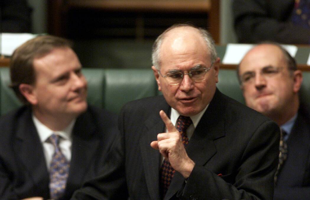 John Howard, with his public service minister Peter Reith (right) and Treasurer Peter Costello (left). Photo: Paul Harris