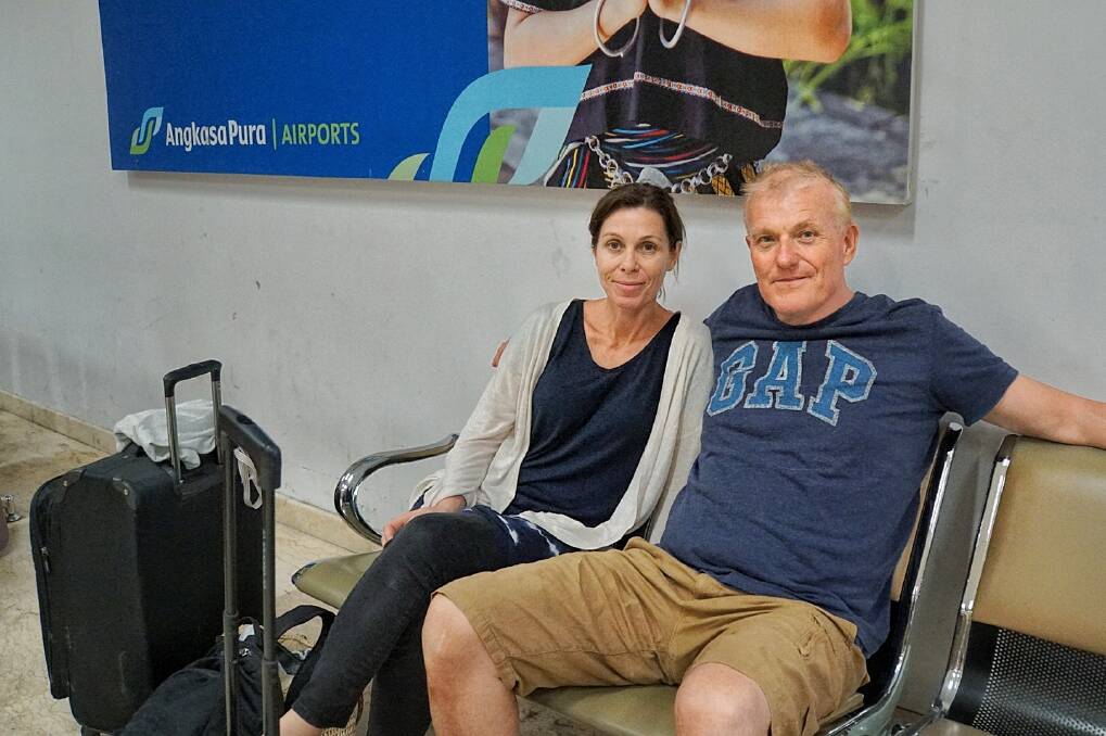 Scherie and John Todd, from Northbridge, Sydney wait at Lombok Airport on Tuesday.  Photo: Amilia Rosa