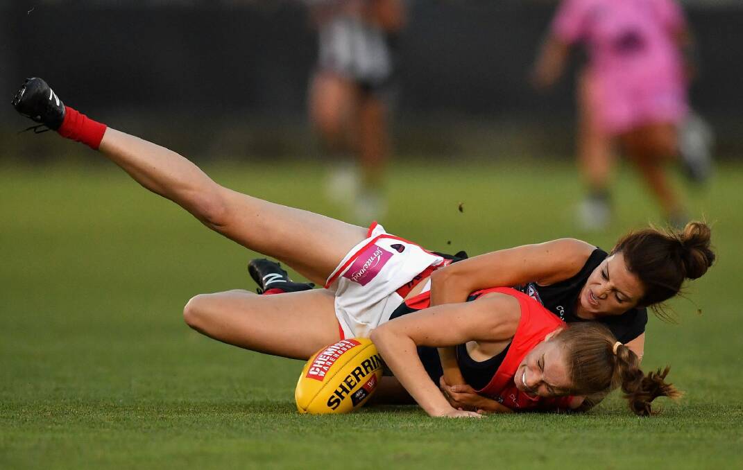 Sarah Lampard of the Demons is tackled by Collingwood's Stephanie Chiocci. Photo: Getty Images