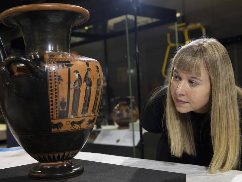 National Museum of Australia curator Lily Withycombe oversees an exhibition of ancient Greek items.