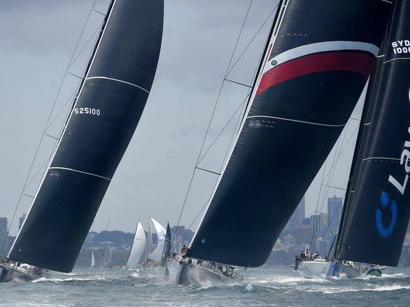 Scallywag (c) led the Sydney to Hobart race early but LawConnect (r) has taken over in front.