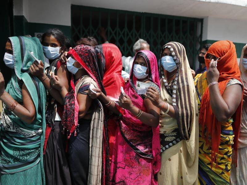 Women wait to cast their votes in local elections in the Indian state of Uttar Pradesh.