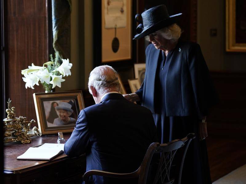 King Charles and Camilla signed a visitors book during a visit to Hillsborough Castle in Belfast. (AP PHOTO)