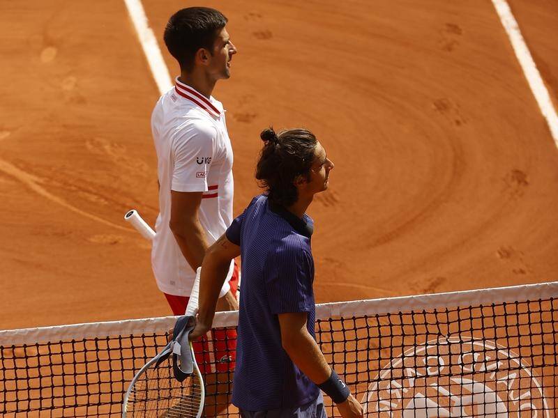 Novak Djokovic is into the French Open quarter-finals after a scare against Lorenzo Musetti (front).