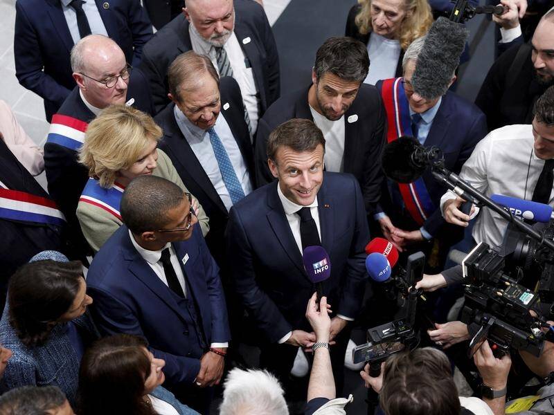 Emmanuel Macron telling reporters in Paris that he has no doubt Russia will target the Olympics. (AP PHOTO)