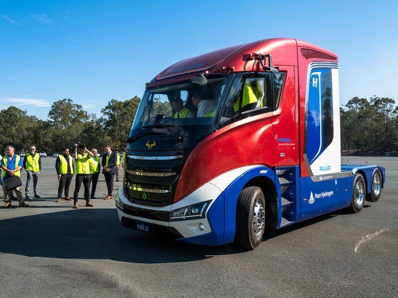Queensland Energy Minister Mick de Brenni sits behind the wheel of a hydrogen-powered prime-mover. (Jennifer Dudley-Nicholson/AAP PHOTOS)