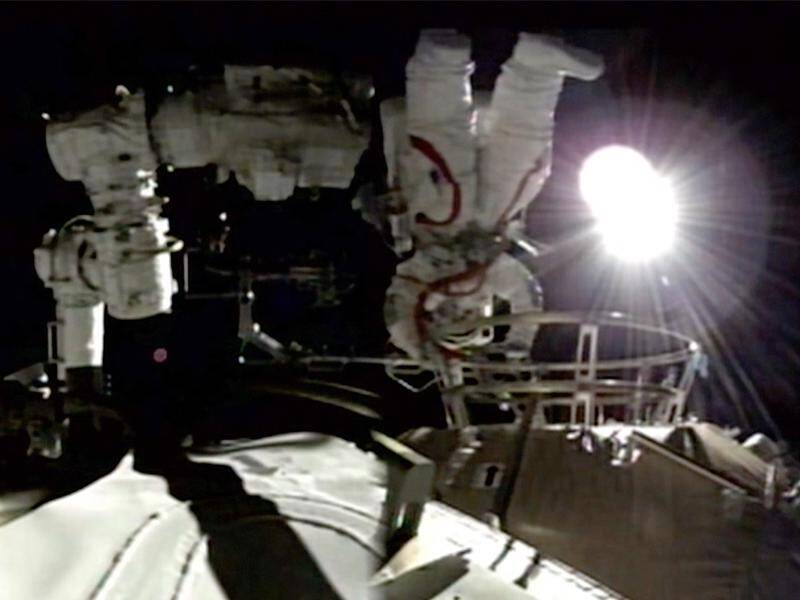 Chinese astronauts took their first walk while in orbit on the country's new space station.