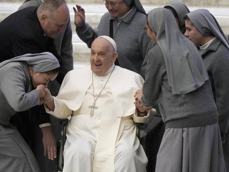 The Pope has been greeted by nuns after arriving for his weekly general audience at the Vatican. (AP PHOTO)