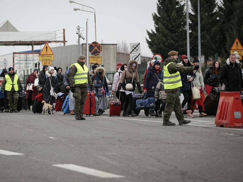 People fleeing Ukraine at the Polish border. The UN says refugees could top 1.5 million within days.