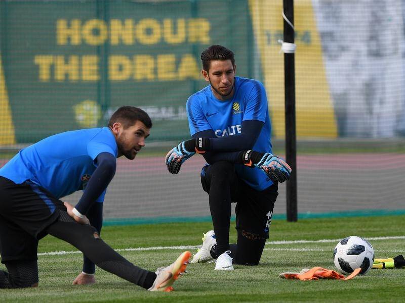 Brad Jones (right), who won six caps for the Socceroos, has retired from professional football. (Dean Lewins/AAP PHOTOS)