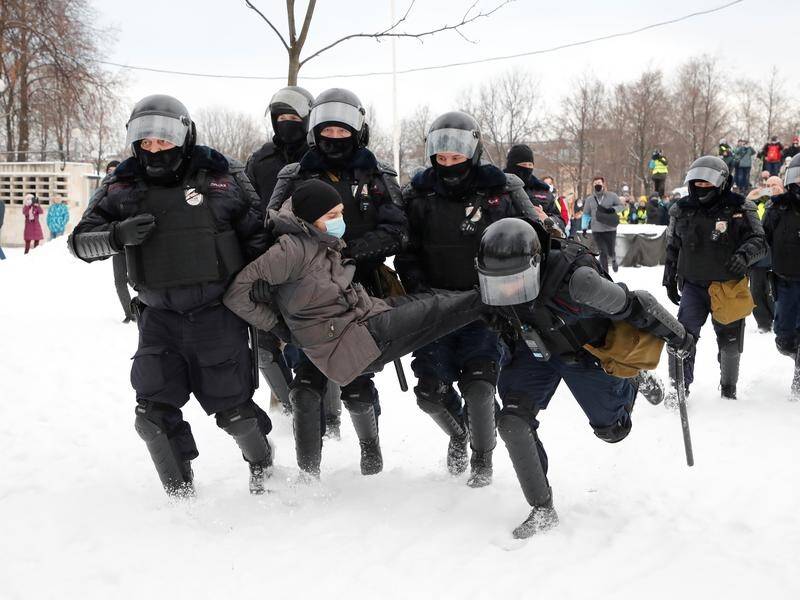 A pro-Navalny protester is detained by police in St Petersburg, Russia.