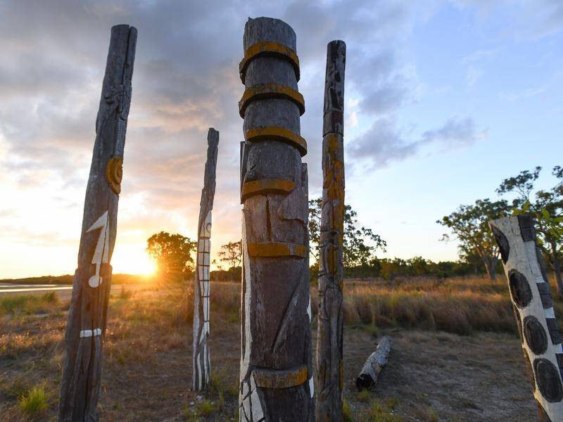Indigenous totems created by artist Thancoupie sit near Bouchat beach in far north Queensland. (AAP Image/Jono Searle)