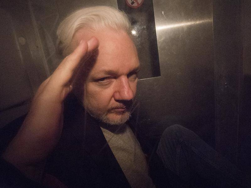 'I do not wish to surrender myself ... for doing journalism that has won ... awards, Assange says.