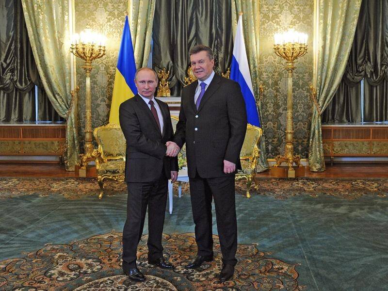 Ex-Ukrainian leader Viktor Yanukovich (right) faces treason charges over a deal with Russia.