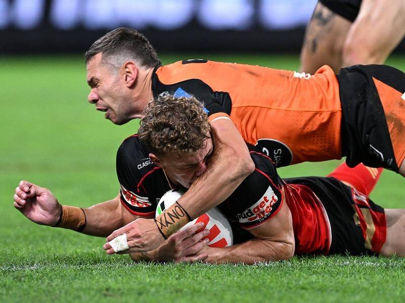 Wests Tigers centre Brent Naden collects Dolphins winger Jack Bostock in the head with his forearm. (Dave Hunt/AAP PHOTOS)