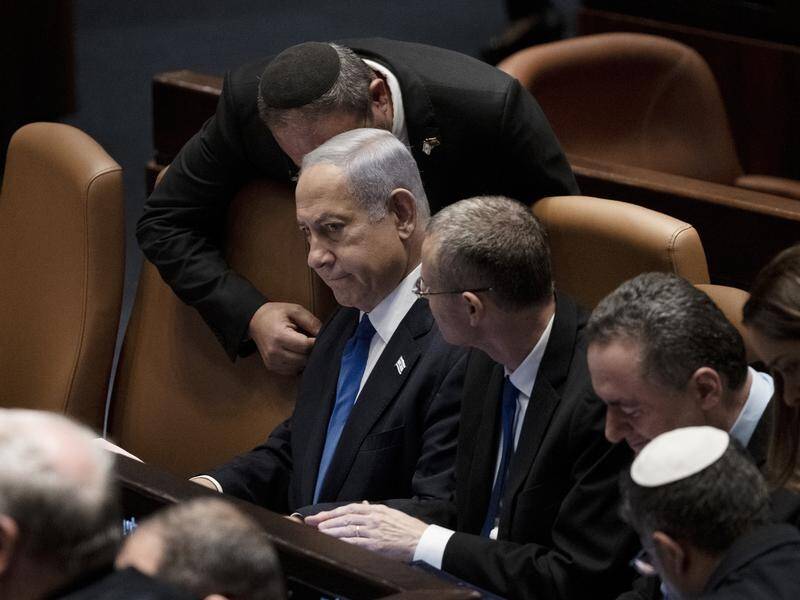 Israel's Benjamin Netanyahu (centre) has downplayed the consequences of his judicial reform plans. (AP PHOTO)