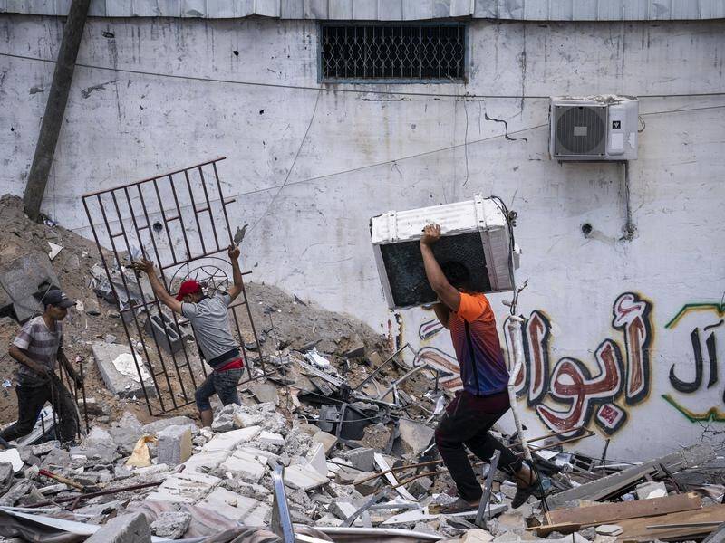 People search rubble after an 11-day war between Gaza's Hamas rulers and Israel, in Gaza City.