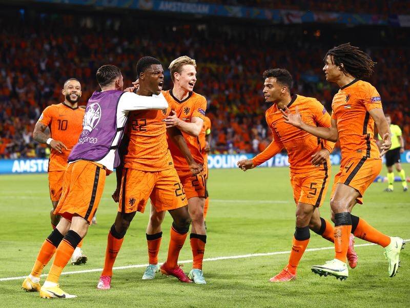 Denzel Dumfries (c) celebrates his Euro 2020 game-winning goal against Ukraine in Amsterdam.