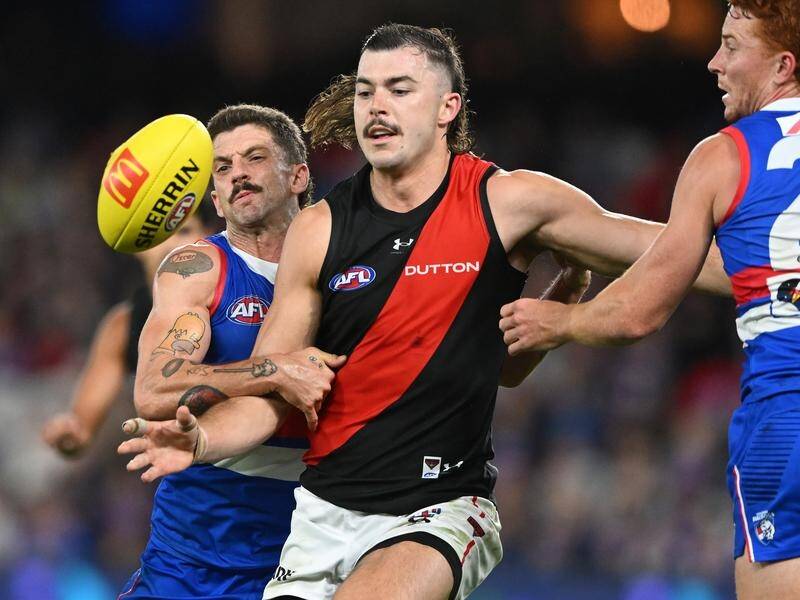 Essendon's Sam Draper (centre) will be sidelined for up to eight games after a knee arthroscopy. (James Ross/AAP PHOTOS)