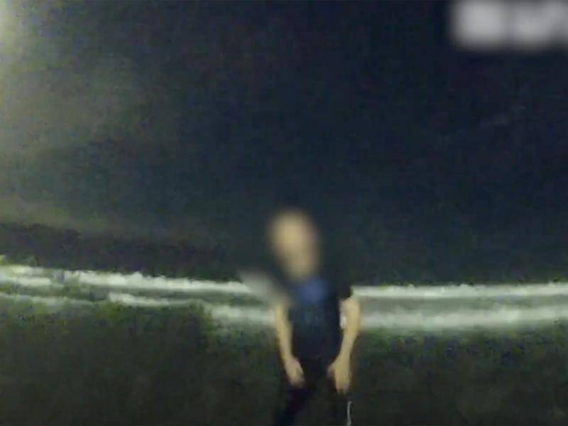 A teenager accused of armed robbery was arrested by police in the Gold Coast surf. (HANDOUT/QUEENSLAND POLICE)