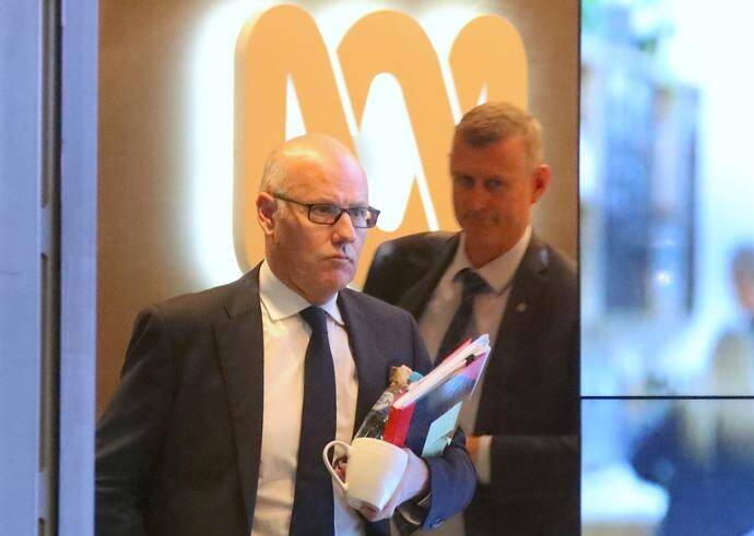 Two federal police agents leave the ABC's headquarters last month after a raid linked to 2017 reports. Picture: David Gray