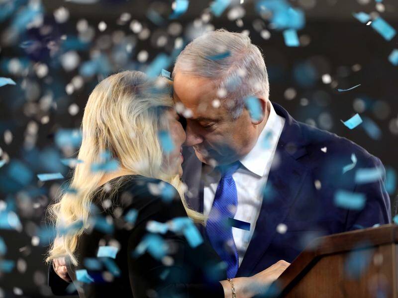 Israel's PM Benjamin Netanyahu has won re-election in a close vote but he still faces graft charges.