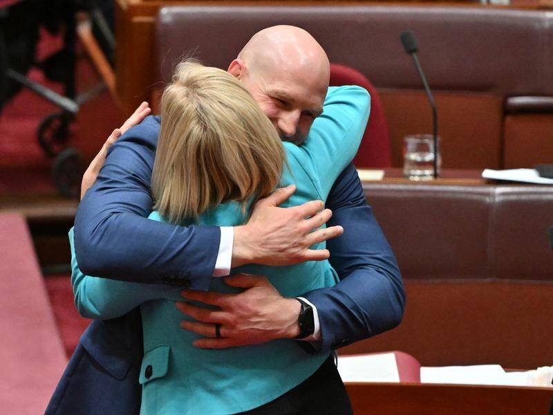 Senators cheered and hugged as the Territory Rights Bill was passed in the Senate. (Mick Tsikas/AAP PHOTOS)