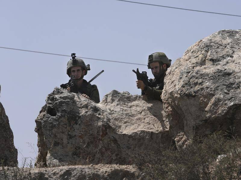 Israeli forces raided a town in the West Bank after three Israeli people were killed in three days. (AP PHOTO)