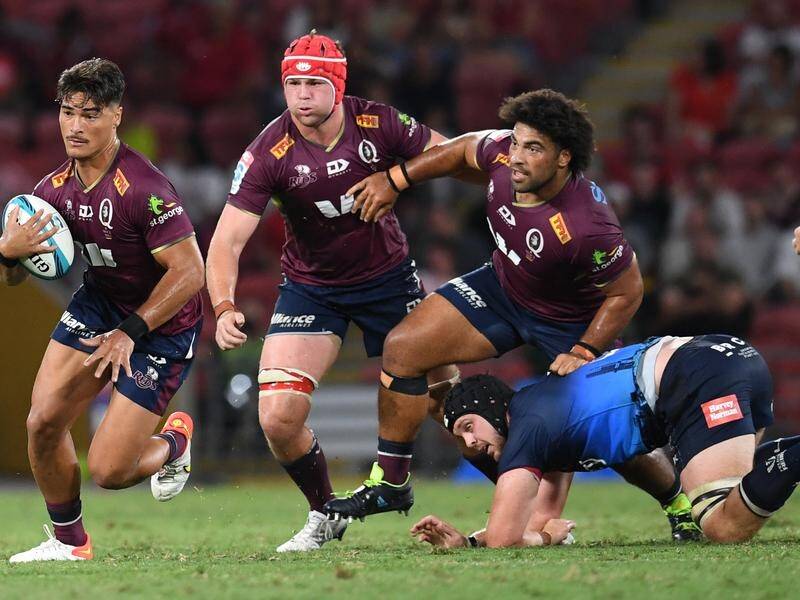 Queensland Reds' Harry Wilson (back) watches Jordan Petaia bust a tackle against Melbourne Rebels.