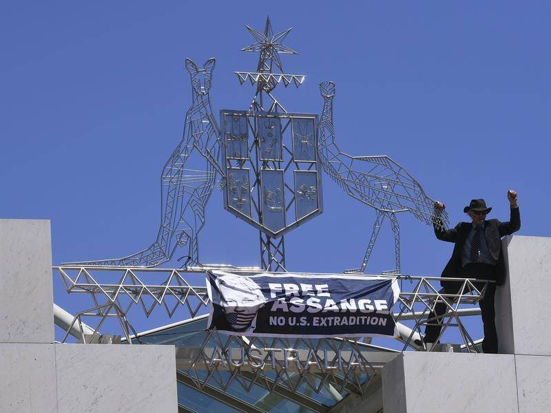 Parliament House security is being reviewed after a pro-Assange protester scaled the building.