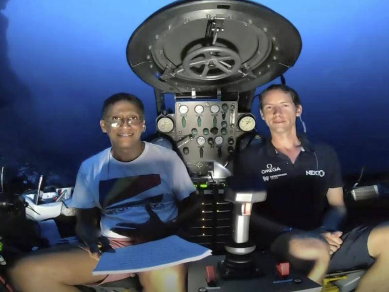 Seychelles President Danny Faure, left, after speaking from inside a submersible.