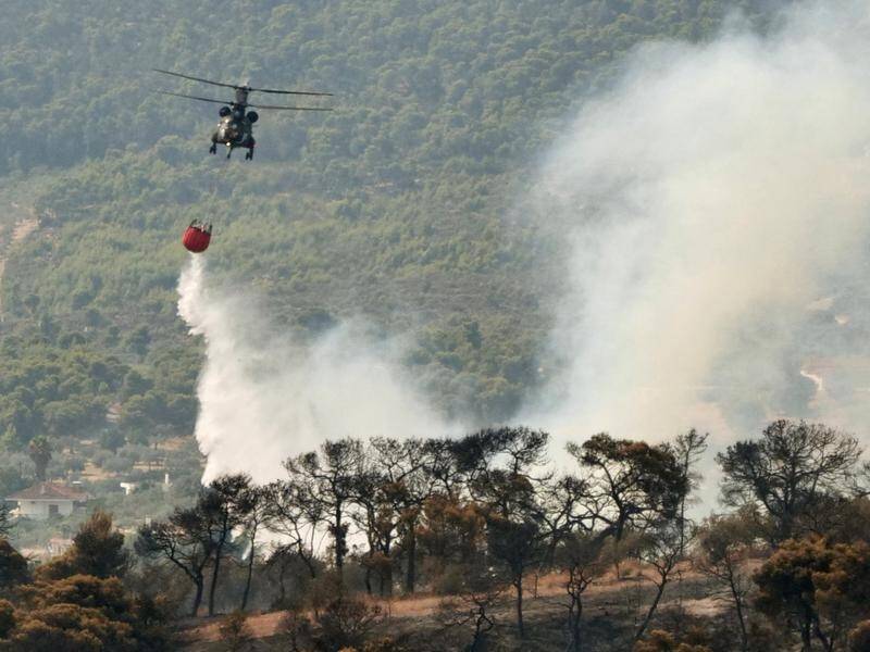 Hundreds of firefighters and several aircraft are battling a wildfire threatening Greek villages.