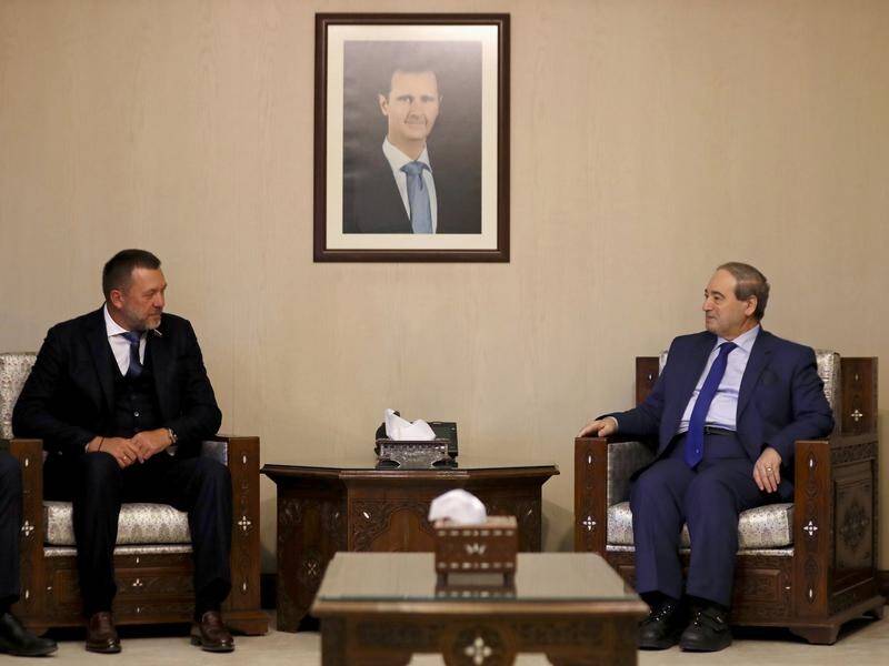 Foreign Minister Faisal Mekdad, right, has met with Russian lawmaker Dmitry Sablin.