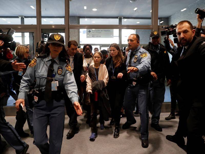Swedish activist Greta Thunberg ()c) arrives for the fifth day of the UN Climate Change Conference.